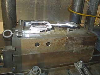 Die making side covers for a light base that goes under a sink on a submarine or boat